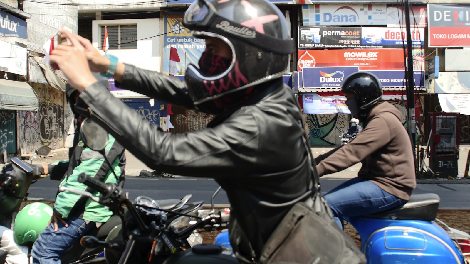 A helmeted motorcycle rider prepared for the road